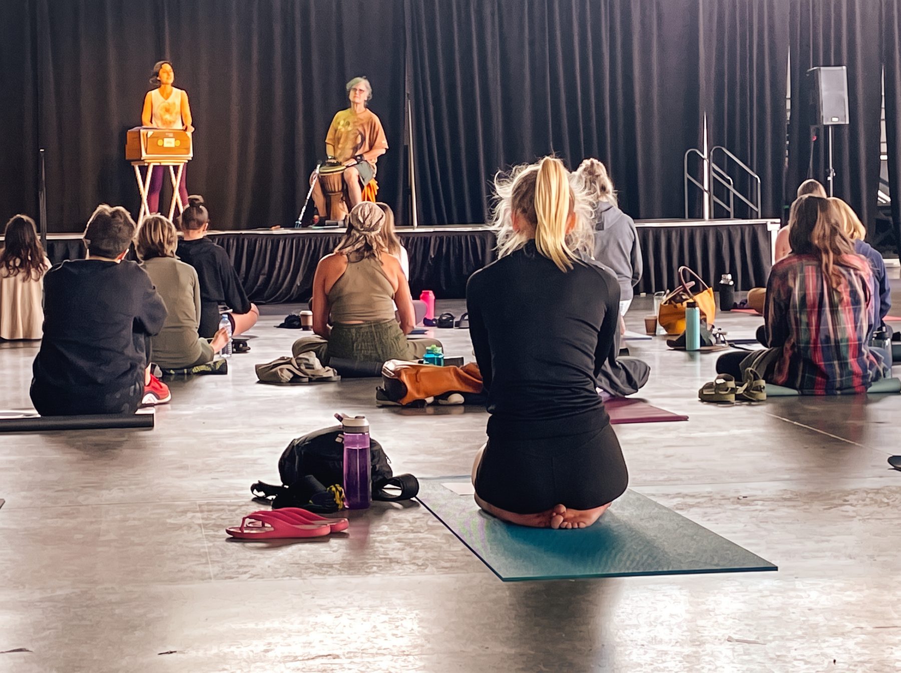 SOULHUM on stage at a festival with audience seated on mats